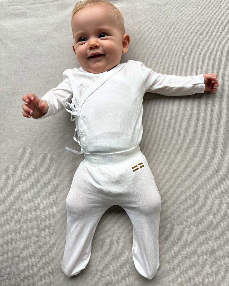 Baby trägt hautfreundliche TRUSTGARN Kleidung aus weichem, atmungsaktivem Stoff für empfindliche Haut und Neurodermitis